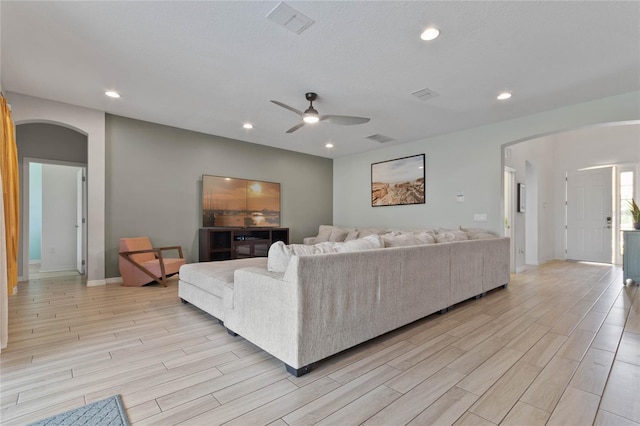 living room featuring ceiling fan and light hardwood / wood-style flooring