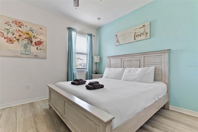 bedroom featuring ceiling fan and light hardwood / wood-style flooring