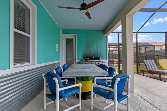 view of patio featuring a lanai, grilling area, and ceiling fan