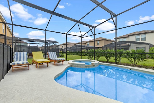 view of swimming pool featuring an in ground hot tub, glass enclosure, and a patio area