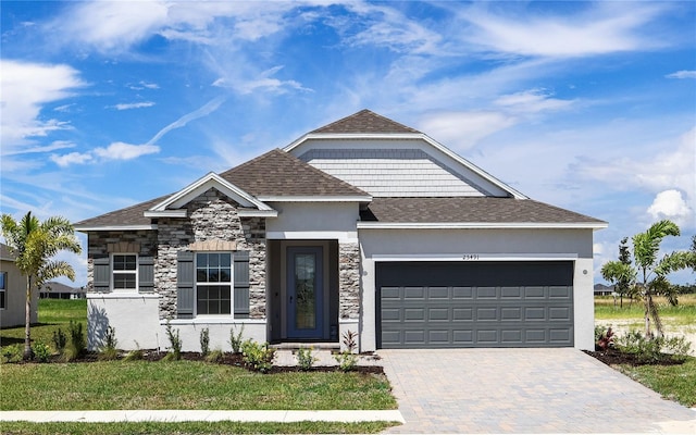 view of front of house with a garage and a front yard