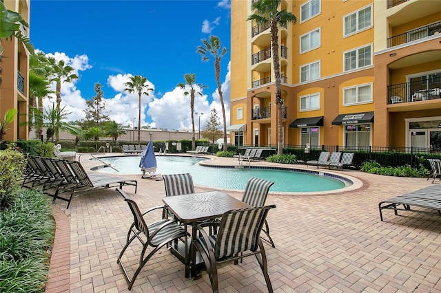 8100 Poinciana Blvd Unit 2212, Orlando, FL 32821 - community pool featuring a patio and fence