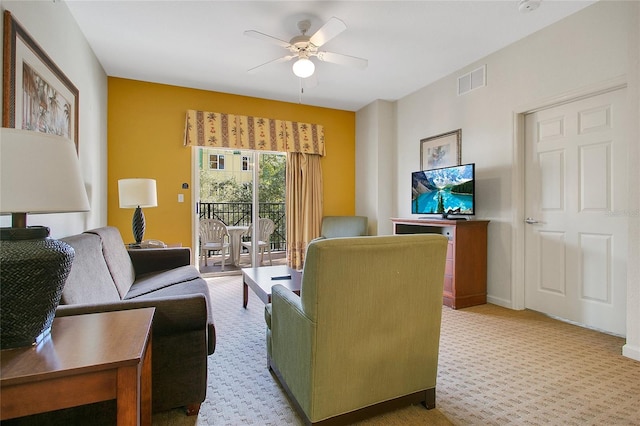 living room with ceiling fan and carpet flooring