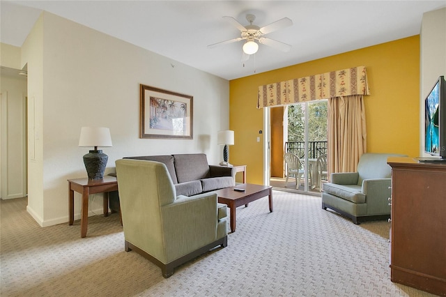 carpeted living room with ceiling fan