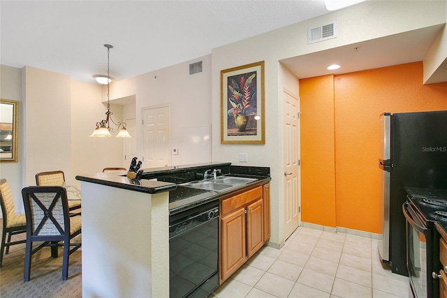 8100 Poinciana Blvd Unit 2212, Orlando, FL 32821 - kitchen with black appliances, a sink, dark countertops, a peninsula, and hanging light fixtures