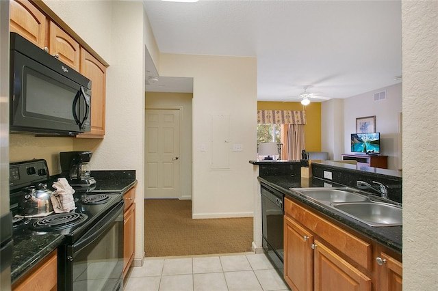 kitchen with sink, black appliances, light colored carpet, and ceiling fan