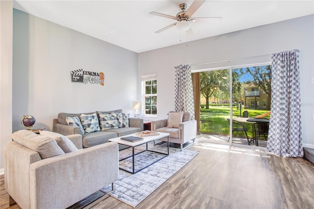 living room featuring light hardwood / wood-style floors, a healthy amount of sunlight, and ceiling fan