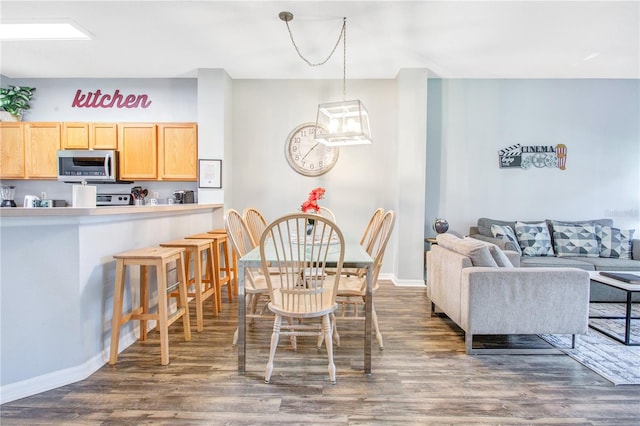 dining space with a chandelier and dark wood-type flooring