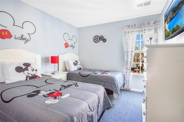 carpeted bedroom with a textured ceiling