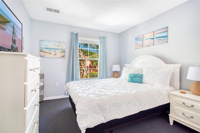 carpeted bedroom featuring a textured ceiling