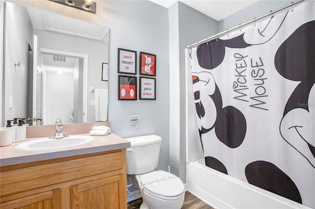 full bathroom featuring toilet, vanity with extensive cabinet space, shower / bath combo, and hardwood / wood-style flooring