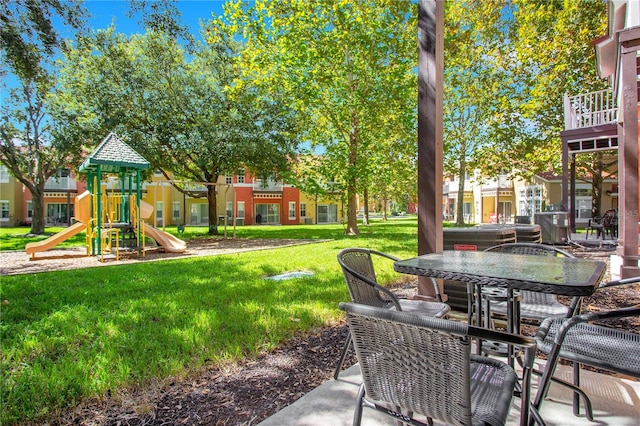 view of yard with a playground and a balcony