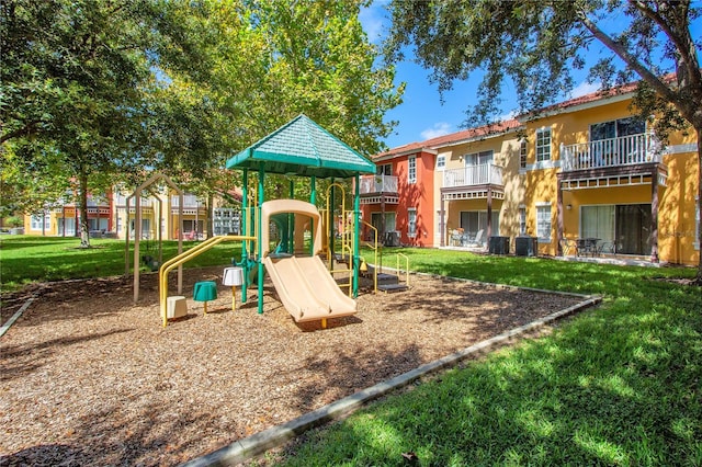 view of jungle gym featuring central AC unit and a yard