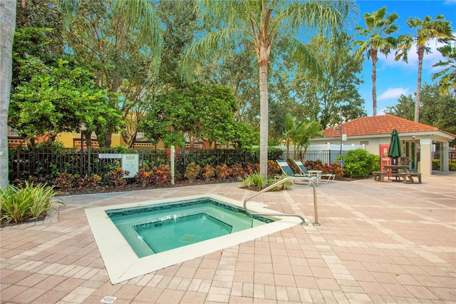 view of pool featuring a community hot tub and a patio