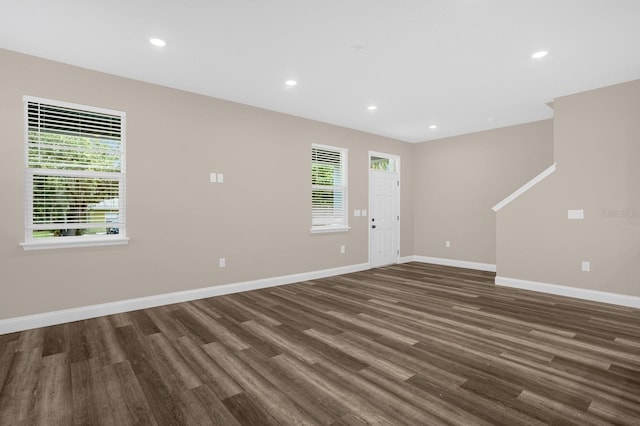 empty room with dark wood-type flooring