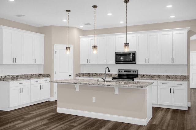 kitchen featuring dark hardwood / wood-style floors, white cabinetry, and appliances with stainless steel finishes