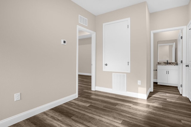 interior space with dark wood-type flooring and sink