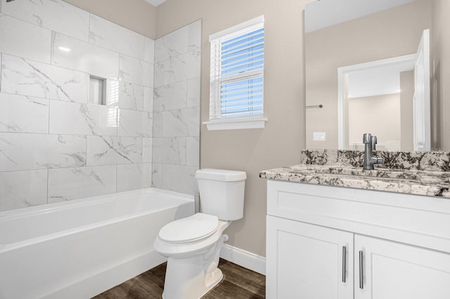 full bathroom with tiled shower / bath, toilet, hardwood / wood-style floors, and vanity