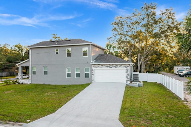 view of front of property featuring a front yard and a garage