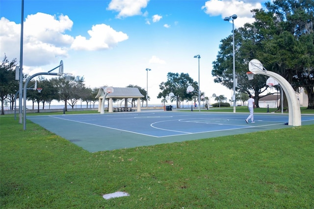 view of sport court with a yard