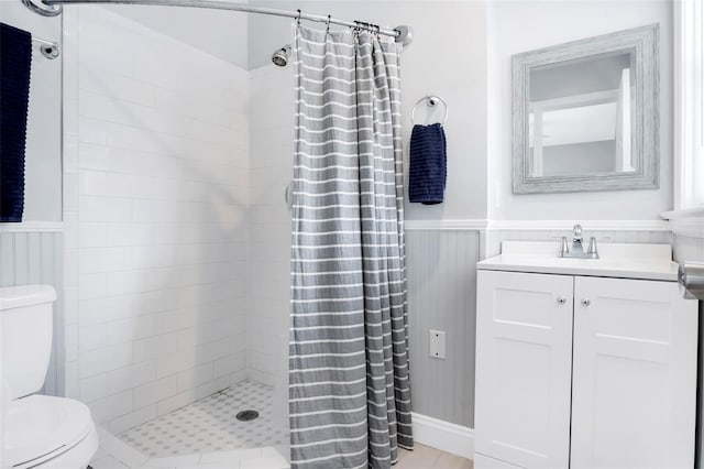 bathroom with walk in shower, toilet, and vanity