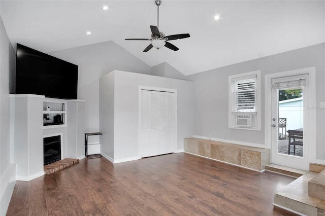 unfurnished living room featuring vaulted ceiling, a brick fireplace, ceiling fan, and dark hardwood / wood-style flooring