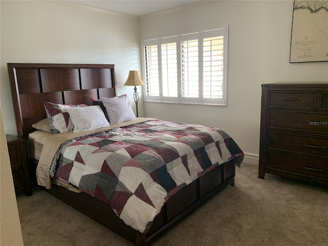 carpeted bedroom with ornamental molding