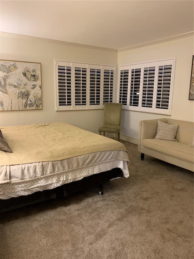 bedroom with crown molding and dark colored carpet