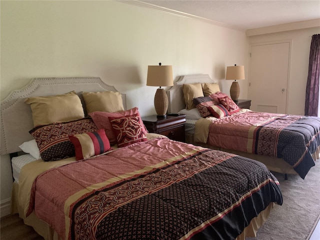 carpeted bedroom with ornamental molding