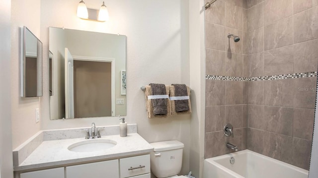 full bathroom with vanity, toilet, and tiled shower / bath combo