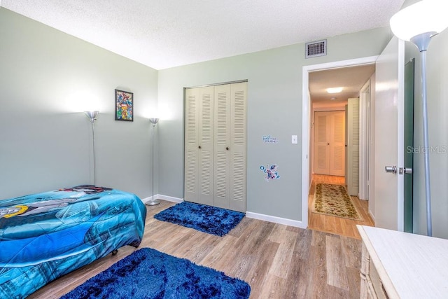 bedroom featuring wood-type flooring and a closet