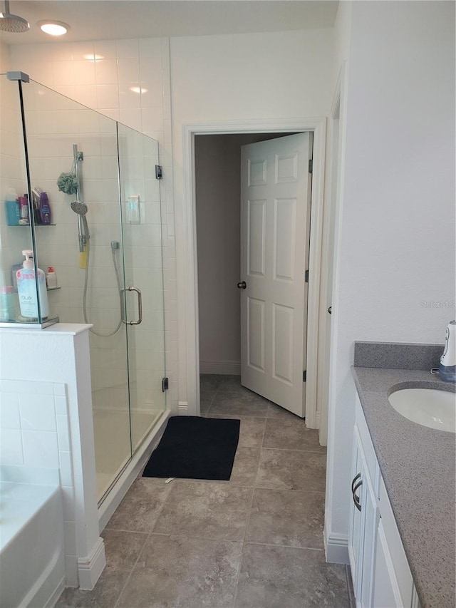 bathroom with plus walk in shower, tile floors, and vanity