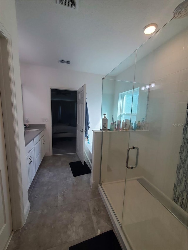 bathroom with concrete flooring, vanity, and walk in shower