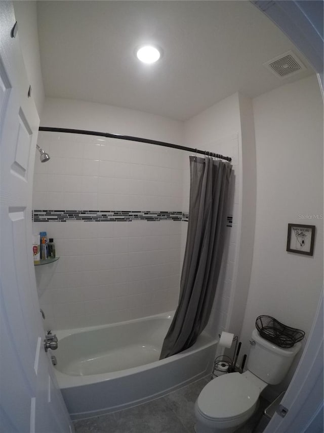 bathroom featuring toilet, tile floors, and shower / tub combo with curtain