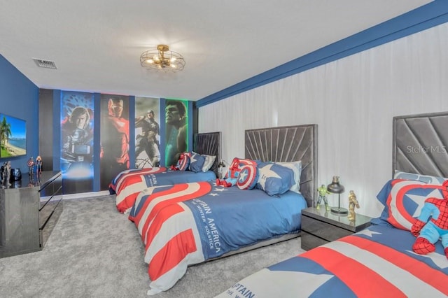 carpeted bedroom with an inviting chandelier