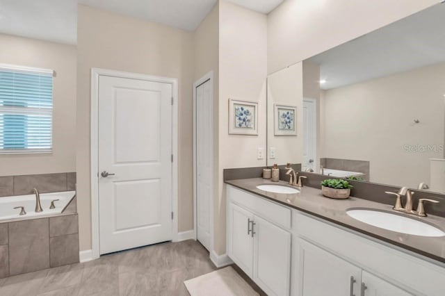 bathroom featuring large vanity, a relaxing tiled bath, dual sinks, and tile floors