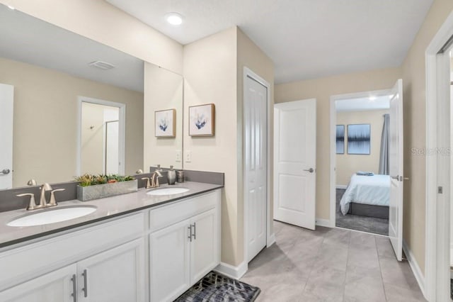 bathroom with tile flooring and double vanity