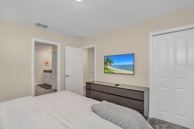 carpeted bedroom featuring ensuite bathroom