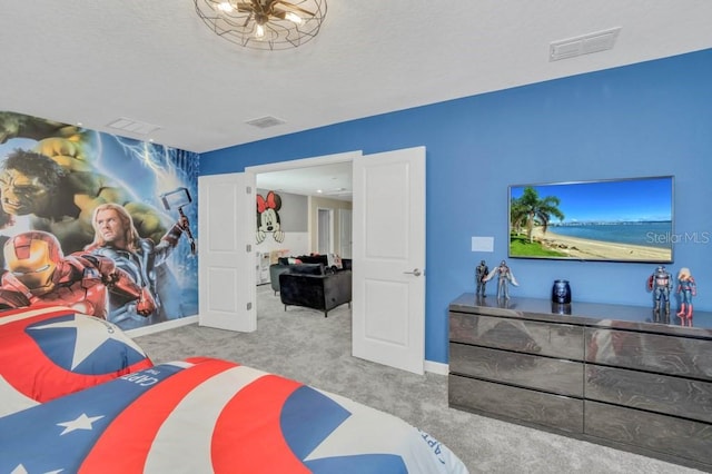 bedroom with light carpet and a chandelier