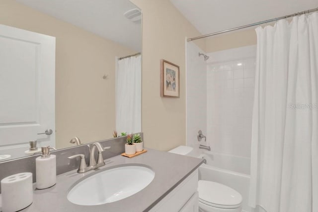 full bathroom featuring shower / tub combo, vanity, and toilet