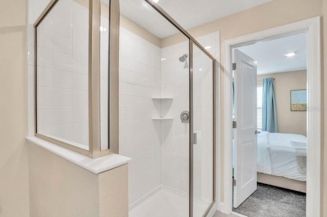 bathroom with a shower with door