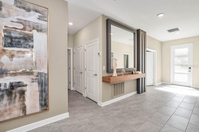 corridor with light tile floors