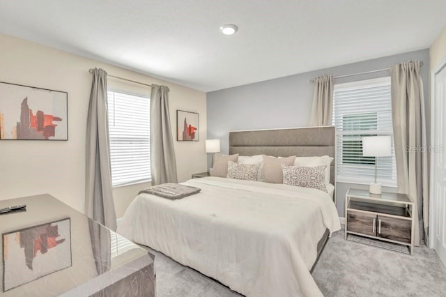 bedroom featuring light colored carpet