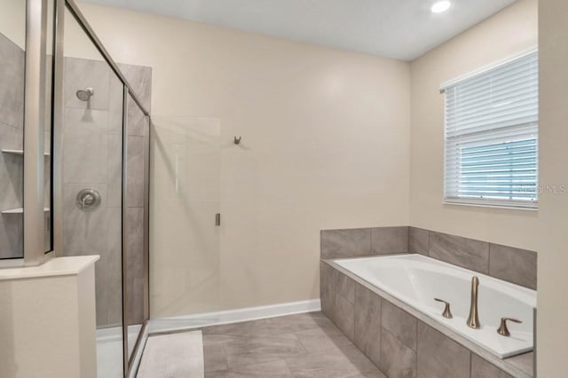 bathroom featuring shower with separate bathtub and tile floors