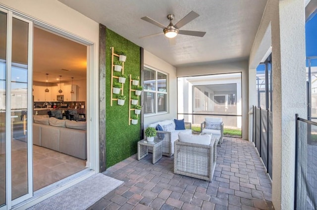 sunroom featuring plenty of natural light and ceiling fan