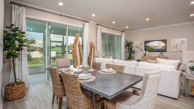 dining space with ornamental molding, recessed lighting, and light wood-style floors