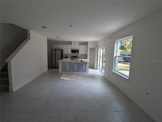 unfurnished living room featuring sink