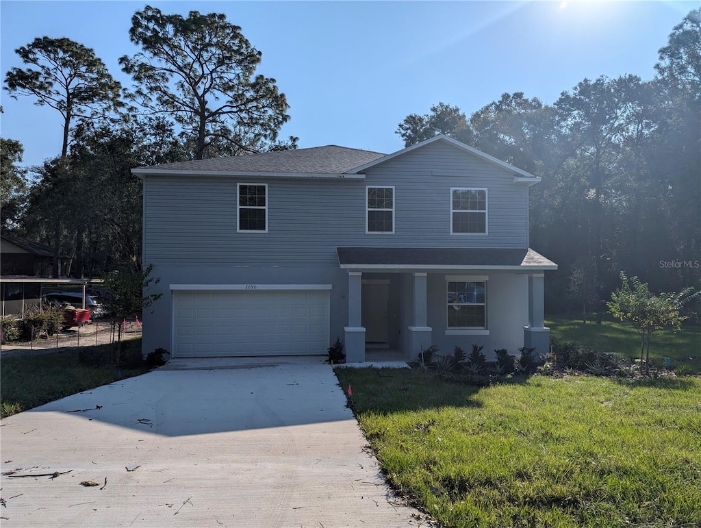 front of property featuring a front lawn and a garage