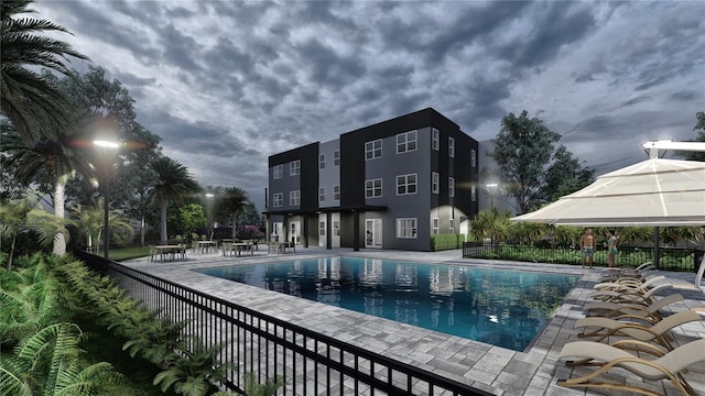 view of swimming pool with a patio, fence, and a fenced in pool