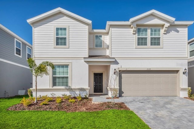 view of front of property with a front lawn and a garage